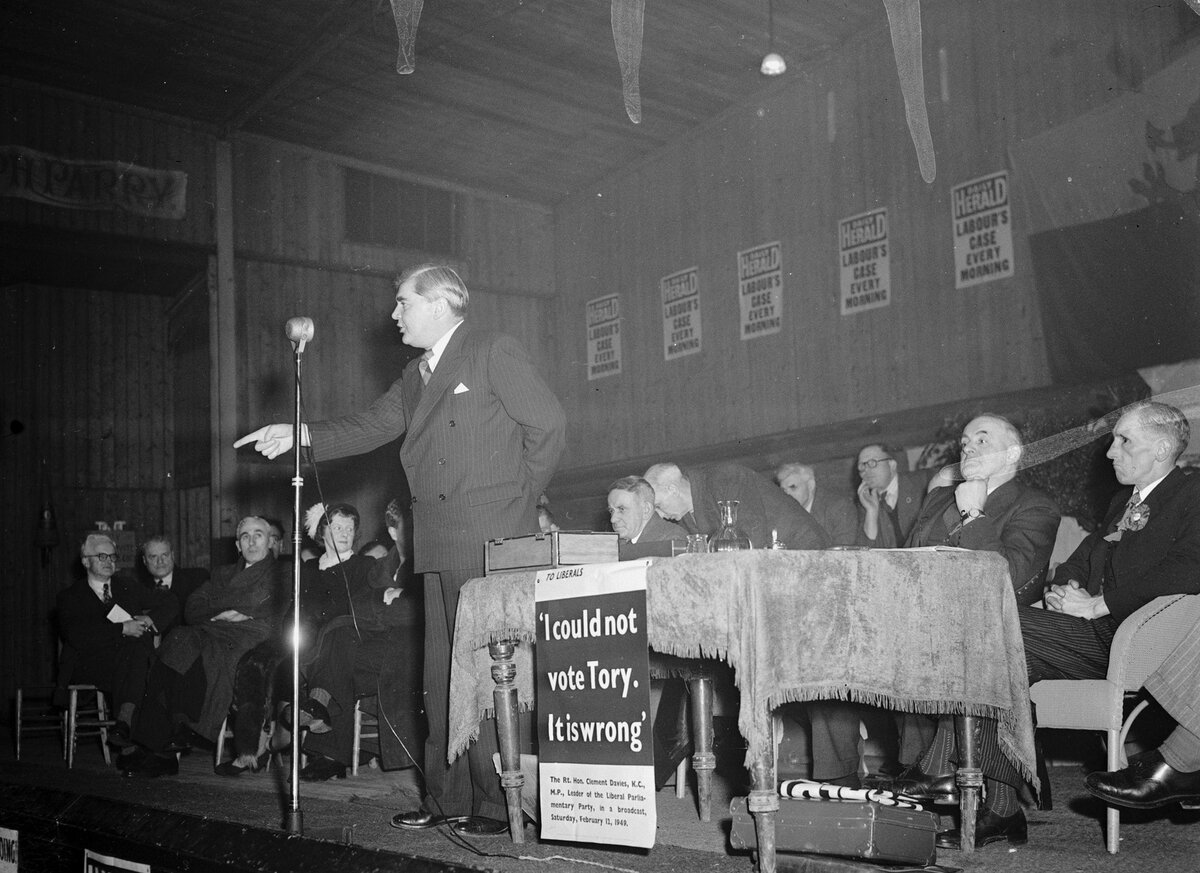 Aneurin Bevan at a national meeting in Corwen Pavilion. (Credit: Geoff Charles, [National Library of Wales](https://commons.wikimedia.org/wiki/File:Aneurin_Bevan_at_a_national_meeting_in_Corwen_Pavillion_(1451252).jpg), CC-BY-SA 4.0.)